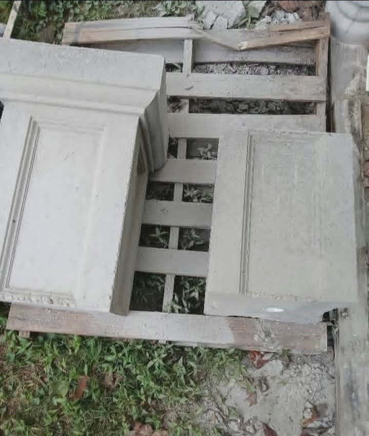 Freshly cast concrete fountain panels curing on a wooden pallet