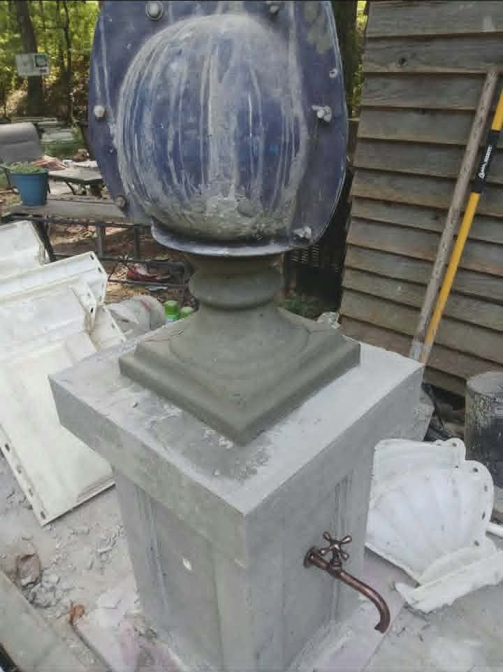 Concrete pillar with copper tap and the finial mold still in place