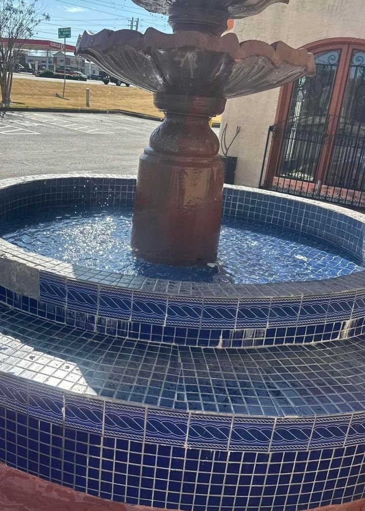 Commercial fountain with aging blue tile before restoration